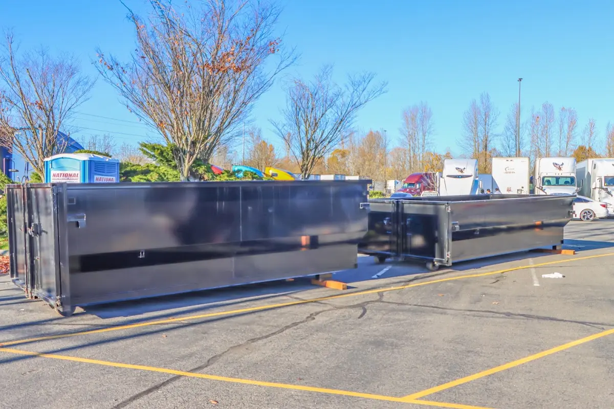 Professional dumpster rental service with roll-off container on residential driveway in Independent Hill